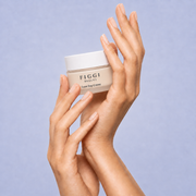 Hands holding FIGGI Luxe Day Crème jar for a morning Green Rooibos skincare ritual